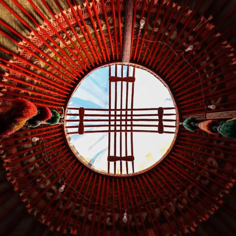 pexels-photo-14917791-14917791 Upward view of the intricate ceiling of a traditional yurt showcasing cultural architecture.